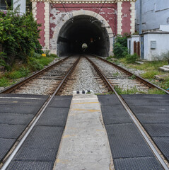 Train tunnel in Sant Pol de Mar, metal tracks.