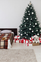 Blue Christmas tree in the bedroom with bed decor pine for the new year with gift card