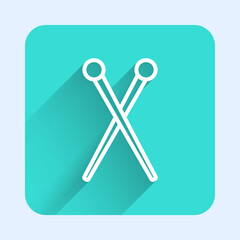 White line Knitting needles icon isolated with long shadow. Label for hand made, knitting or tailor shop. Green square button. Vector Illustration.