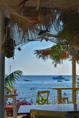 Chiringuito on the beach with tropical style and sea views.