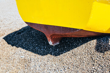 Yellow old boat on the sandy shore - fishing season