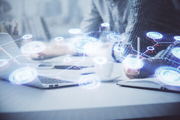 Social network theme hologram with businessman working on computer on background. Concept of world...