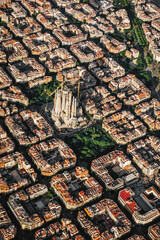 Obraz premium Aerial view of the residential Eixample district of Barcelona, with the Sagrada Familia, Designed by Catalan architect Antoni Gaudi