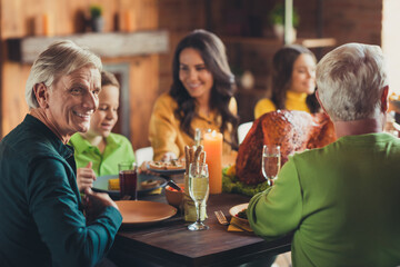 Photo of big family thanks giving event turkey served dinner communicating have fun house living room indoors