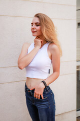 Portrait shooting of a stylish girl. Beige shades. Trends of spring and summer 2020.Black pants and...