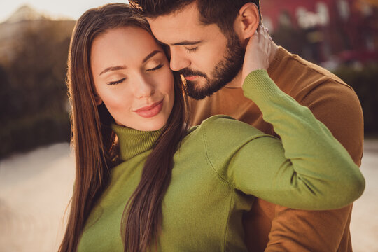 Cropped photo of passionate trust couple girl touch boyfriend face hand in autumn city center park wear turtleneck jumper