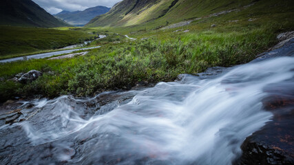 long exposure image of the waterfalls in glen etive in the argyll region of the highlands of scotland during autumn after heavy rainfall