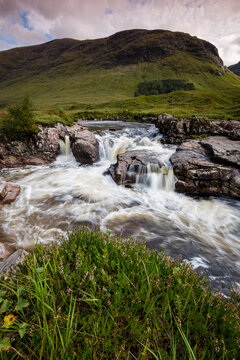 long exposure image of the waterfalls in glen etive in the argyll region of the highlands of scotland during autumn after heavy rainfall