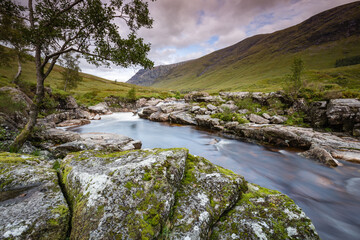 long exposure image of the waterfalls in glen etive in the argyll region of the highlands of scotland during autumn after heavy rainfall