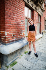 Portrait shooting of a stylish girl. Beige shades. Trends of spring and summer 2020.Black top and beige skirt