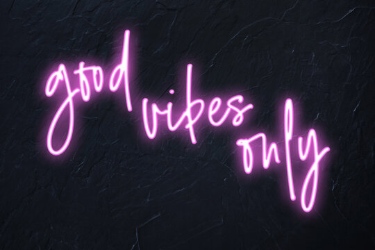 Good vibes only written in pink neon style on black wall background