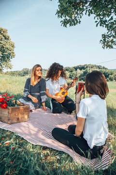 Female friends enjoying a picnic in nature.