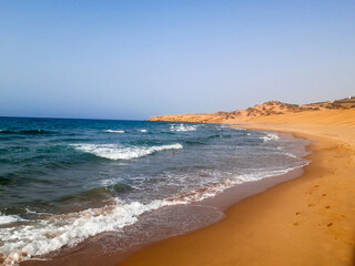 Close-up soft wave of the sea on the sandy beach 