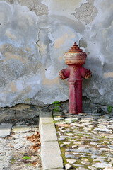 Old red fire hydrant with grunge texture wall background