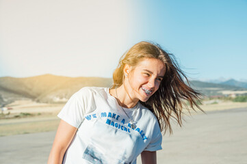 Beautiful young smiling girl with braces on teeth