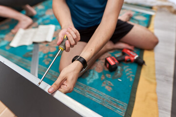Man assembling his new furniture