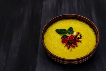 Corn cream soup with fresh vegetables, herbs and spices