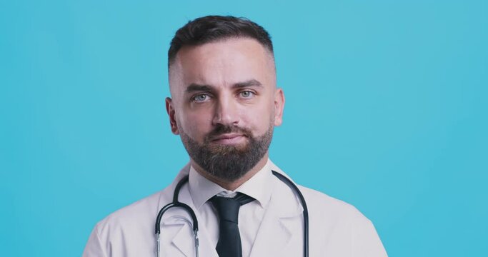 Serious medical doctor shaking head no after contemplating, blue studio background