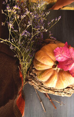 autumn leaves on old wooden table and pumpkin