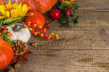 Festive autumn background, with traditional decor - pumpkins, berries, fruits, leaves on old wooden...