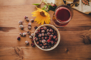 Still life. Frozen cherries and cherry juice on wooden background