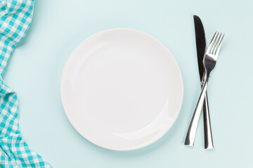 Empty plate, fork and knife