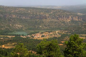 View over the village of Uña abd the Serrania de Cuenca, Spain, on a misty summer day