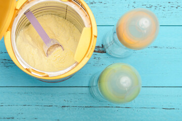 can of powdered milk with two baby bottles