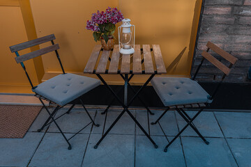 On the terrace there is a wooden table and chairs
.Concept cozy interior