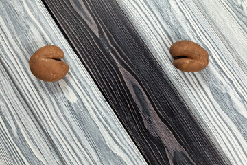 Ugly vegetables. Two funny potatoes with cracks on a black and white wooden textured background....