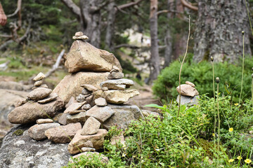 Stones piled up in oriental style pyramid shape with mountain landscape and nature

