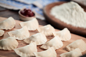 raw dumpling with cherries on the wooden board