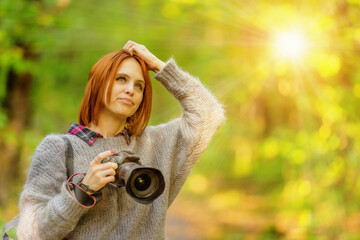 Woman photographer in autumn forest