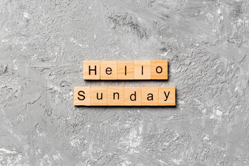 hello sunday word written on wood block. hello sunday text on cement table for your desing, concept