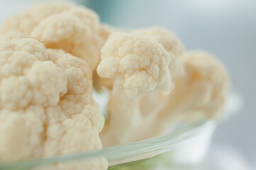 Cauliflower on a light background. Vegetables close-up. Macro photo.