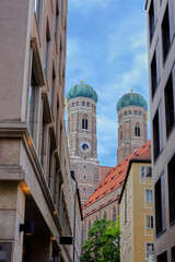 Fototapeta premium View of the towers of Frauenkirche church from one of the streets in Munich