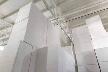 Industrial production of polystyrene foam insulation panels or plates from expanded polystyrene. A large blocks of Styrofoam are stacked in a warehouse. Building materials.