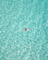 Obraz premium Man chilling in a crystal clear water / Ibiza