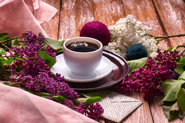 Coffee Cup And Colorful Lilac Flowers On Garden wooden Table