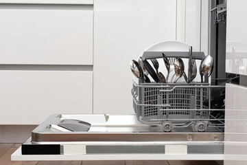 Open dishwasher with clean utensils in it