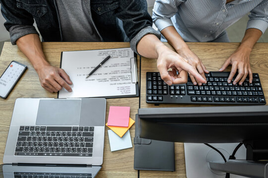 Programmer Team of  Developing programming and website working in a software develop company office, writing codes and typing data code, Programming with HTML, PHP and javascript