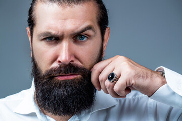 Portrait of bearded male in white shirt. Close up of handsome beard hipster elegant male. Bearded...