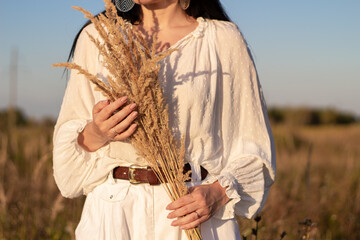 Girl in a field with spikelets