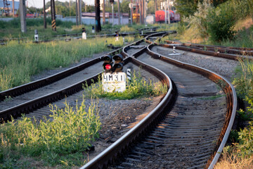 Summer railway tracks overgrown with green grass. Way out.