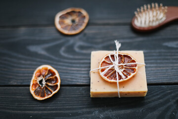 Natural citrus soap on dark background. Concept of Spa, Salon or Home body and skin care. Flat lay. Space for text, top view