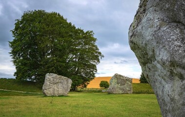 Impressive standing stones from the historic circle in Avebury Wiltshire. Sheep can be seen grazing...