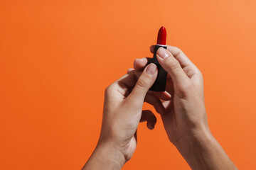 Woman's hand holding red lipstick isolated