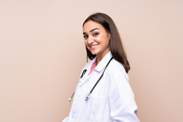 Young woman over isolated background with doctor gown