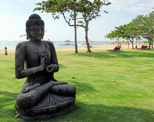 Meditating Buddha statue on Nusa Dua beach in Bali Indonesia - 378346405