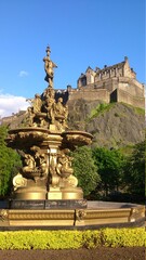 low angle view of fountain in front of edinburgh castle on top of the hill